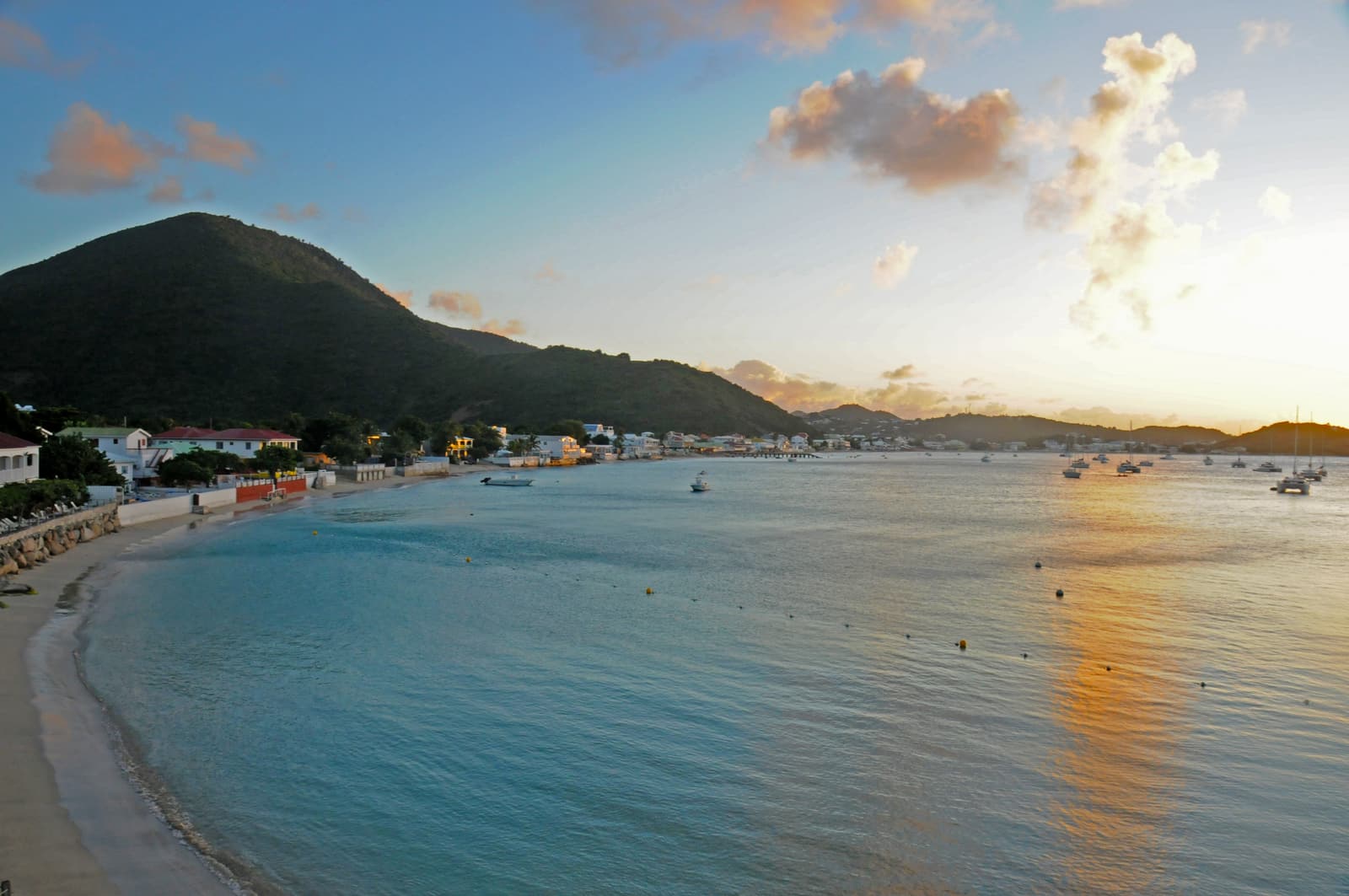 Grand Case bay at dusk with its beach, village and hills