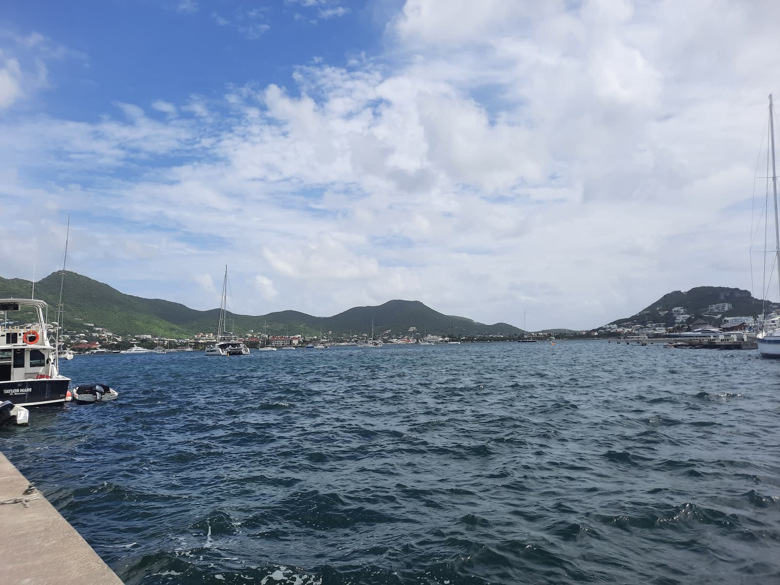 Yachts moored in the Simpson Bay Lagoon with green hills behind