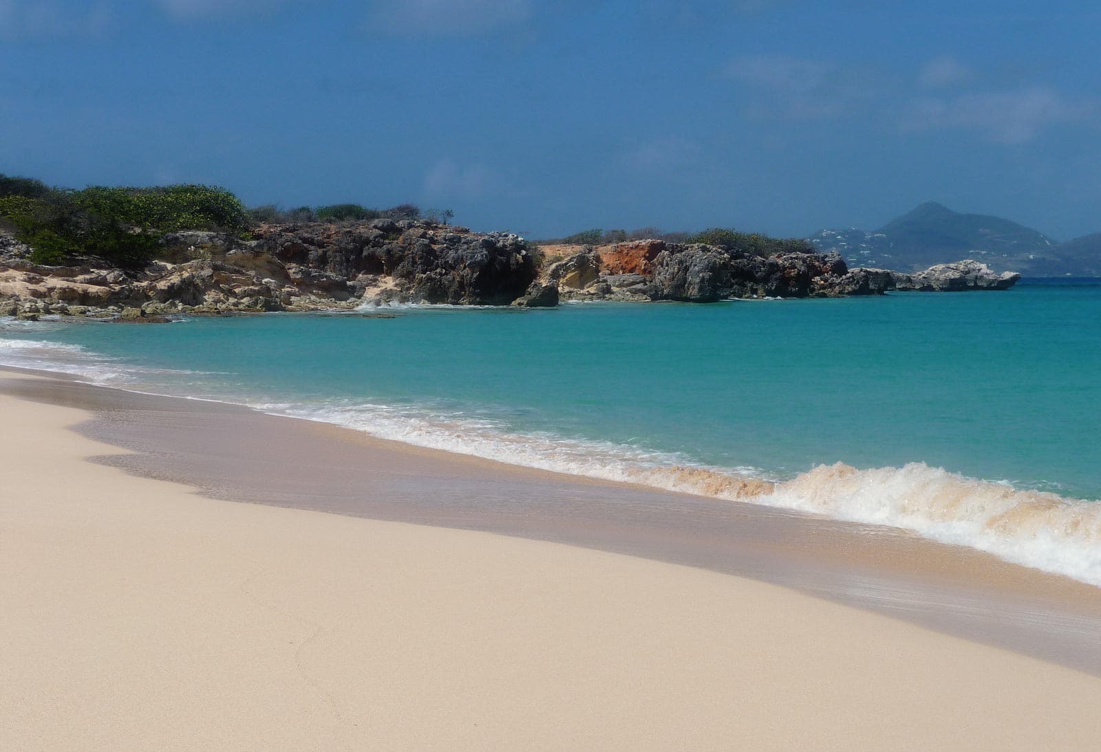 The white beach and low cliffs of Baie Blanche on Tintamarre