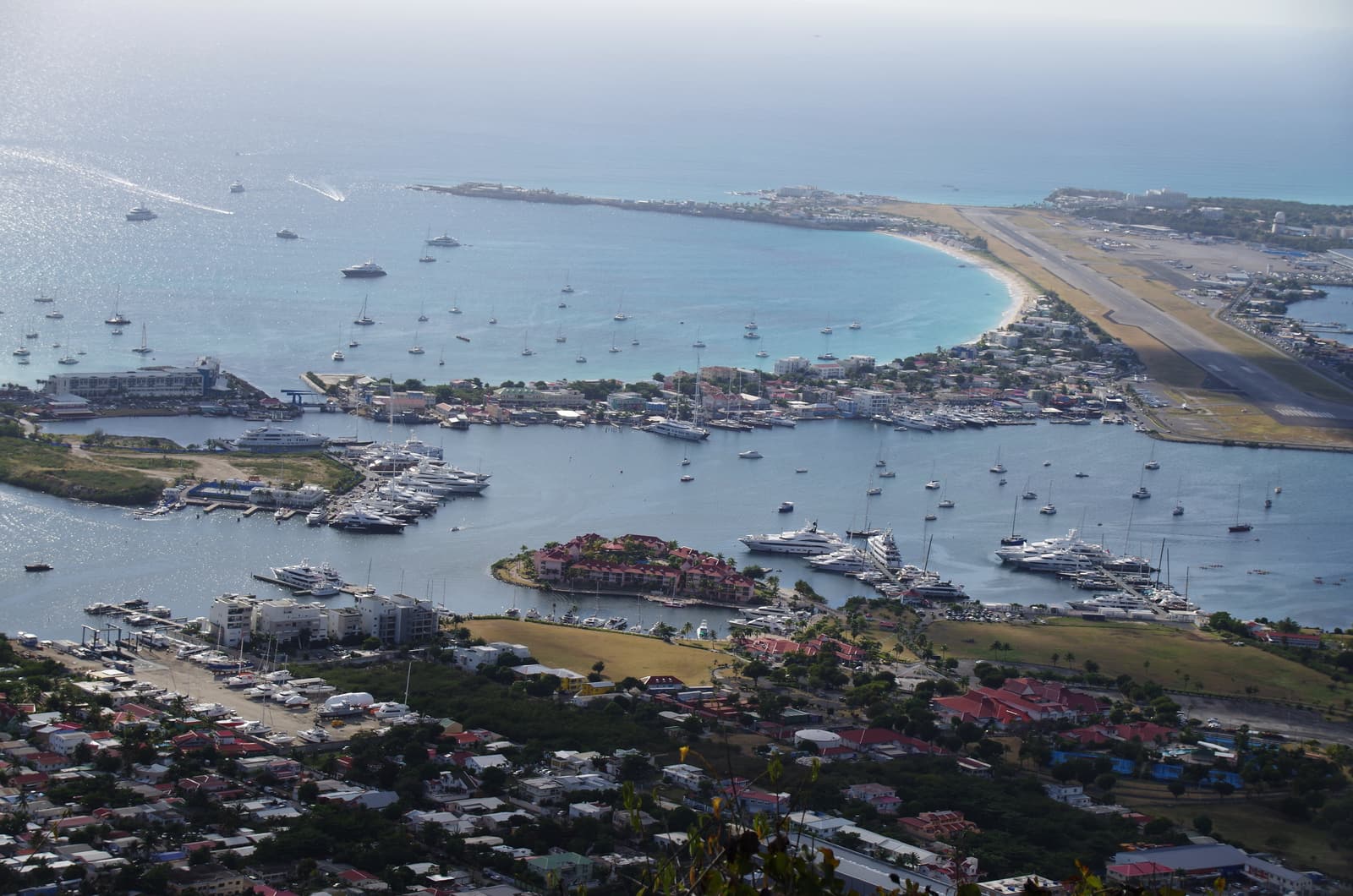 Aerial view of the Simpson Bay Lagoon, its marinas and the airport runway